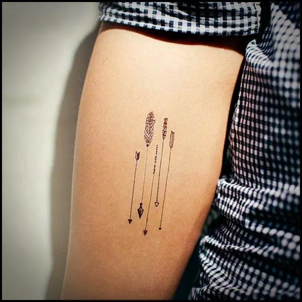 Figuras pequeñas tatuadas en el brazo de un hombre
