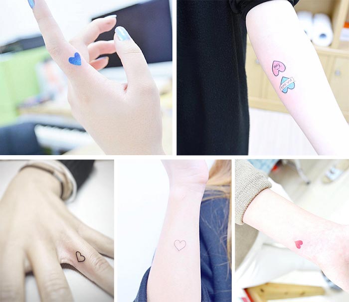 tatuajes pequeños de corazones de diferentes colores en manos y antebrazos. 