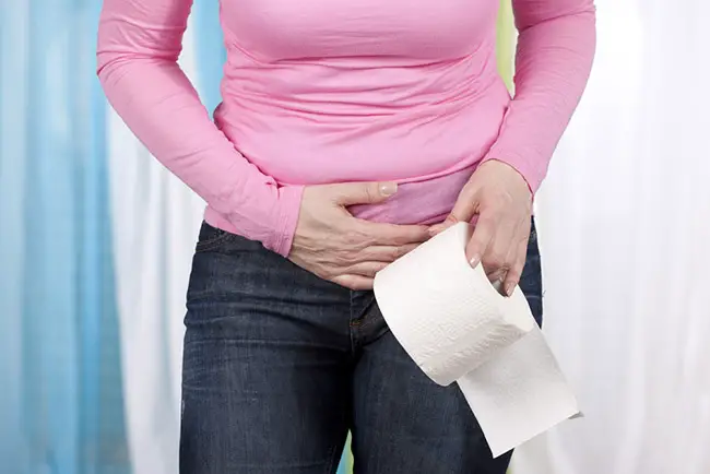 Mujer con problemas intestinales or comer un alimento caducado