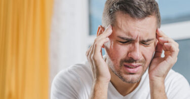 Hombre con dolor de cabeza por deficiencia de minerales