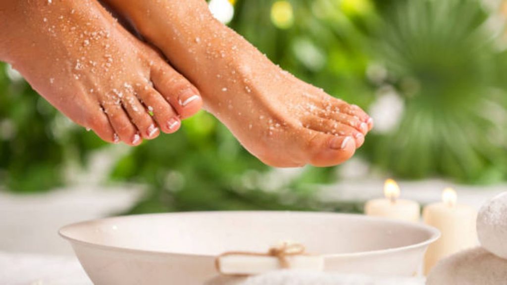 Mujer aplicándose avena para las piernas secas